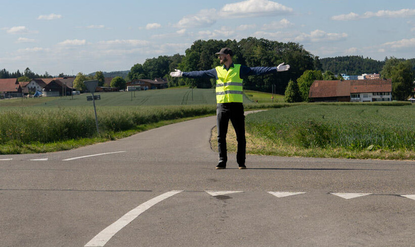 man giving instructions at crossroads